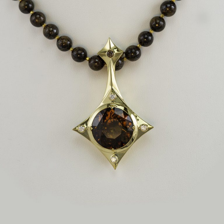 Sphene pendant with dimaond accents.