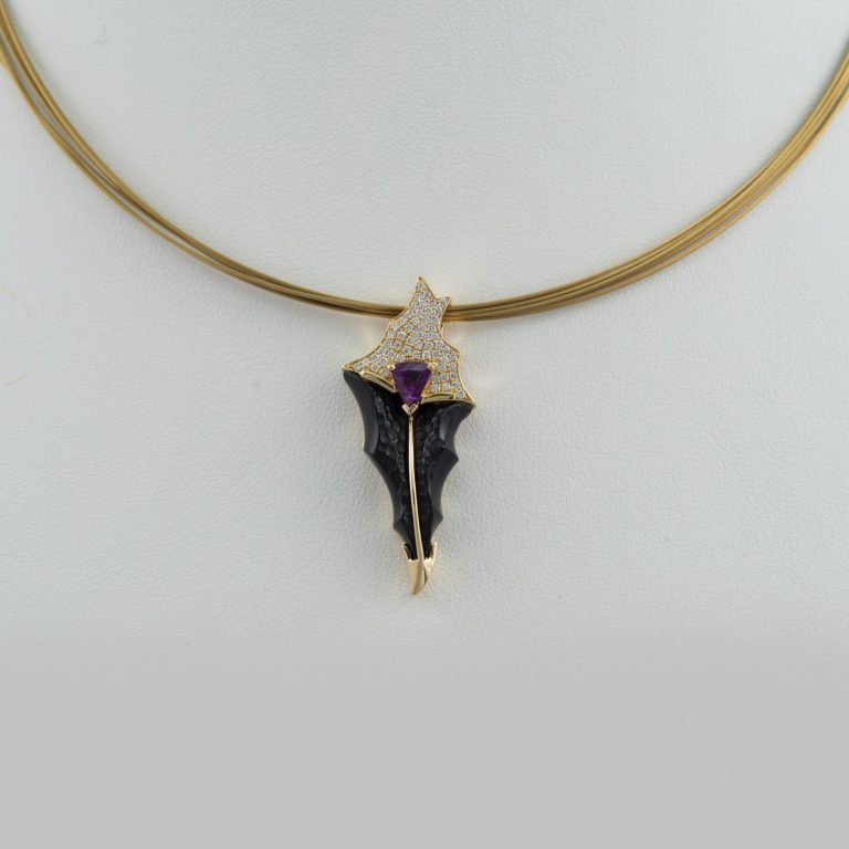 Carved Onyx pendant with Grape Garnet and Daimond accents. All the stones were set in 18kt yellow gold. Chain not included.