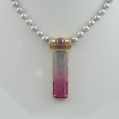 Bi-color tourmaline pendant with fancy sapphires