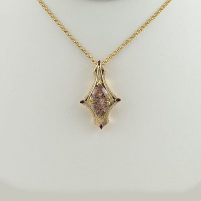 One of a kind Morganite pendant with rubies, diamonds, and 18kty gold. This pendant is comprised of two matching morganite stones. Chain not included.