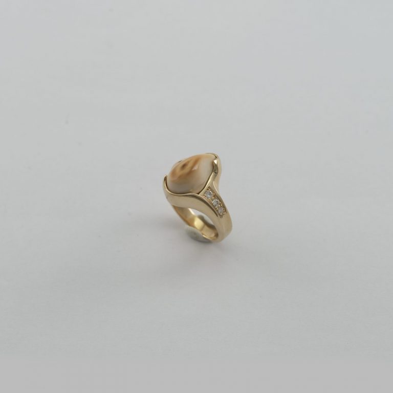 Ivory ring with Diamonds. This bull elk ivory has been set in 14kt gold. We also have several pairs of earrings to match.