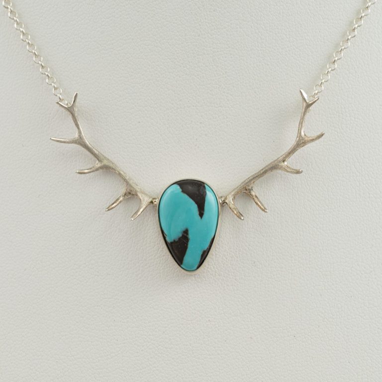 Sterling Silver Antler Pendant with Carico Lake Turquoise. The chain is 16" in length. We have multiple versions of the Turquoise and antler pendant.