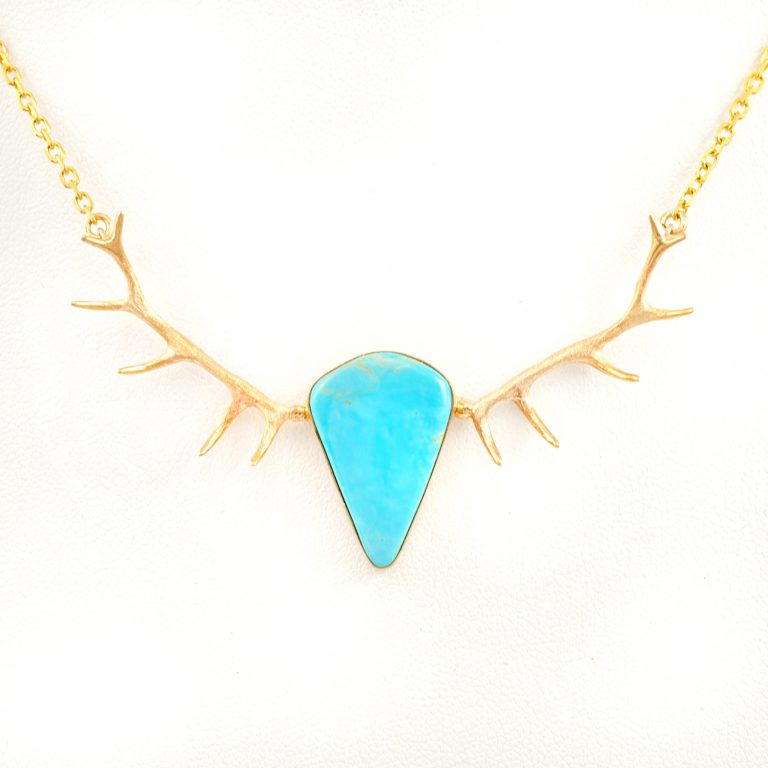 This is our Kingman Antler Necklace. The turquoise has been set in 14kt yellow gold. The turquoise is from the kingman mine.