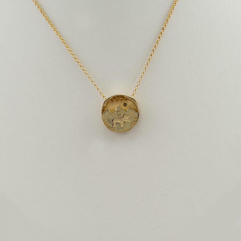 Wyoming black jade teton pendant in 14kt yellow gold with a diamond. The diamond is a brilliant-cut, white diamond. Chain not included.