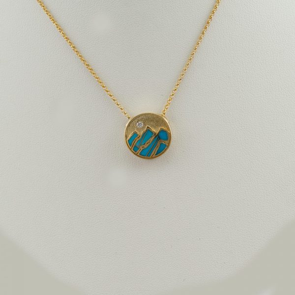 Small Turquoise Teton Pendant in 14kt yellow gold. It is accented with a briliant-cut, white Diamond. The chain is not included in the price.