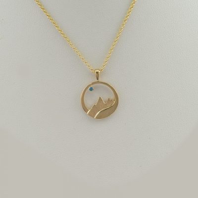 14kt teton pendant with a Blue Diamond. This is part of our Teton flow collection. The chain is not included in the price.