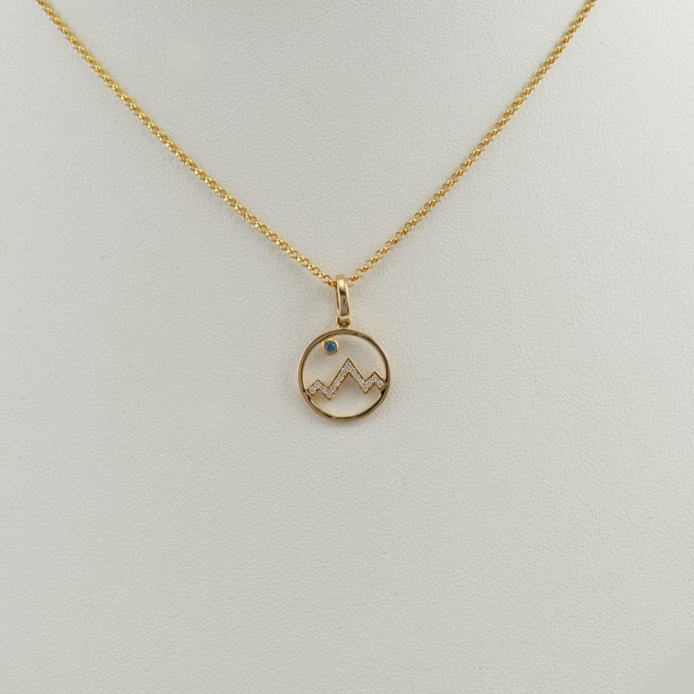 Teton diamond line design with Blue diamond moon. Set in 14kt yellow gold. The chain is not included in the price of the pendant.