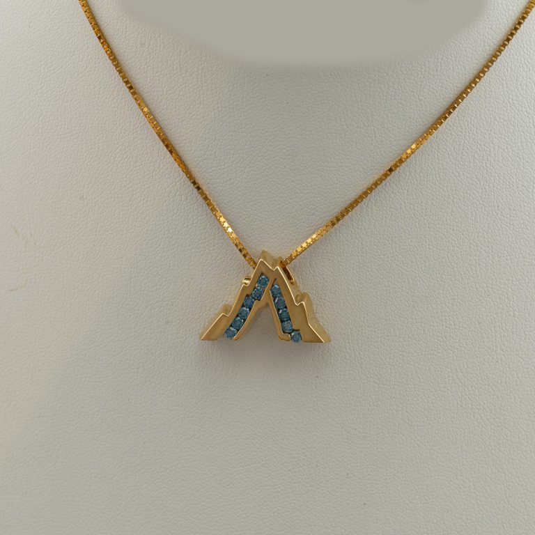 Large Teton with Blue Diamonds in 14kt yellow gold. We also have earrings to match. The chain is not included in the price.