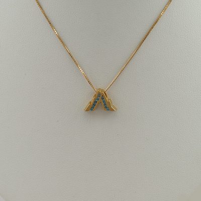 Blue diamond teton pendant in 14kt yellow gold. The diamonds are brilliant-cut and channel set in the gold. Chain not included.