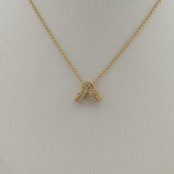 This is the Medium Grand Teton slide. It has been cast in 14kt yellow gold and has Diamond accents. The chain is not included in the price.