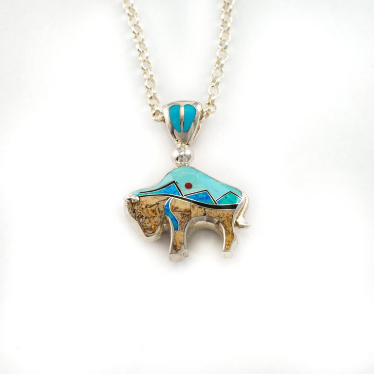 This is our Large bison pendant with sleeping beauty turquoise. It has been cast in Sterling Silver and the inlay has been done by hand.