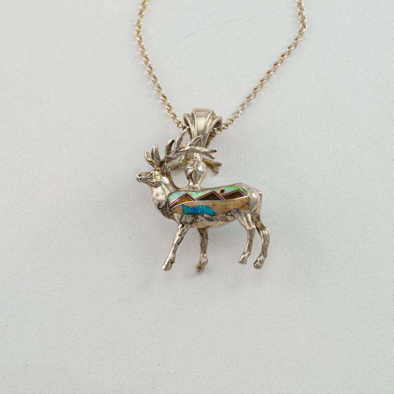 This is the Reversible elk pendant with hand-done inlay. It has been cast in Sterling Silver and the inlay is on both sides. The chain is included.