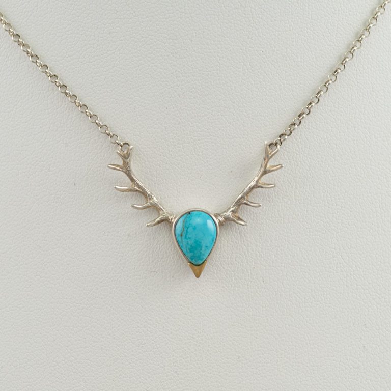 This is our Sterling Silver antler necklace with turquoise and 14kt yellow gold. The chain can be adjusted to any length you would like.