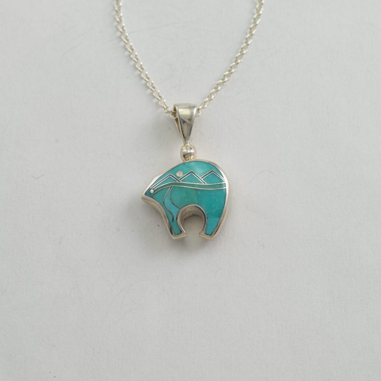 This is the bear pendant in Sterling Silver. The pendant is inlaid by hand. It is reversible and made in America. The chain is included.