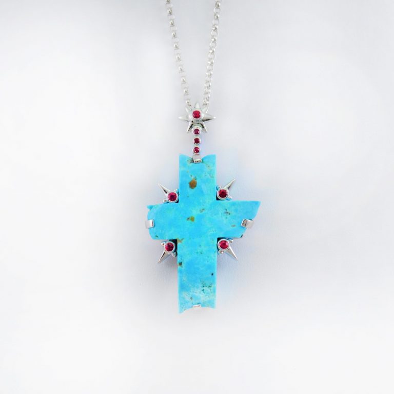 This is a Turquoise cross with Ruby accents. Both the Truquoise and the Rubies have been set in Rhodium-plated Sterling Silver.