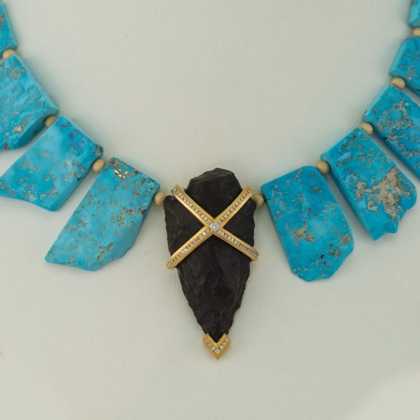 Arrowhead pendant with diaomds, turquoise, and plated gold.