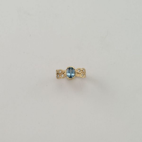 Aquamarine ring with diamond accents. Cast in 14kt yellow gold.