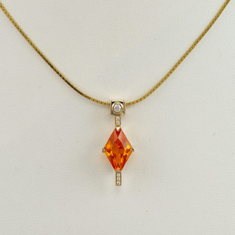 Fire opal pendant in yellow gold with white diamond accents