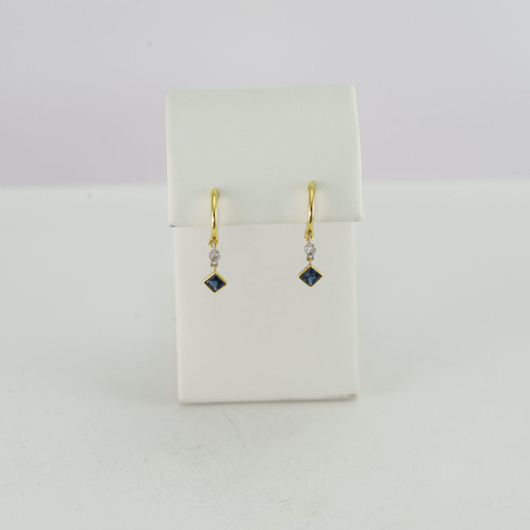 Sapphire earrings with diamond accents and two tone gold.