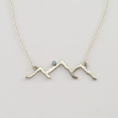 Teton line design in sterling silver with blue diamond accent