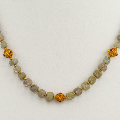 Raw diamond necklace with ruby accents in 24kt gold.