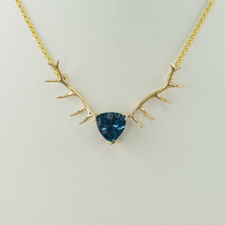 This is our Topaz Antler necklace. The Topaz is Swiss blue in color and 6.67ct in size. The chain has a lobster claw clasp and is included.