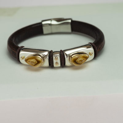 Here is an Elk Ivory bracelet that incorporates Silver, Gold, Leather and a magnetic clasp. Shown in a size 8, but can be re-sized.