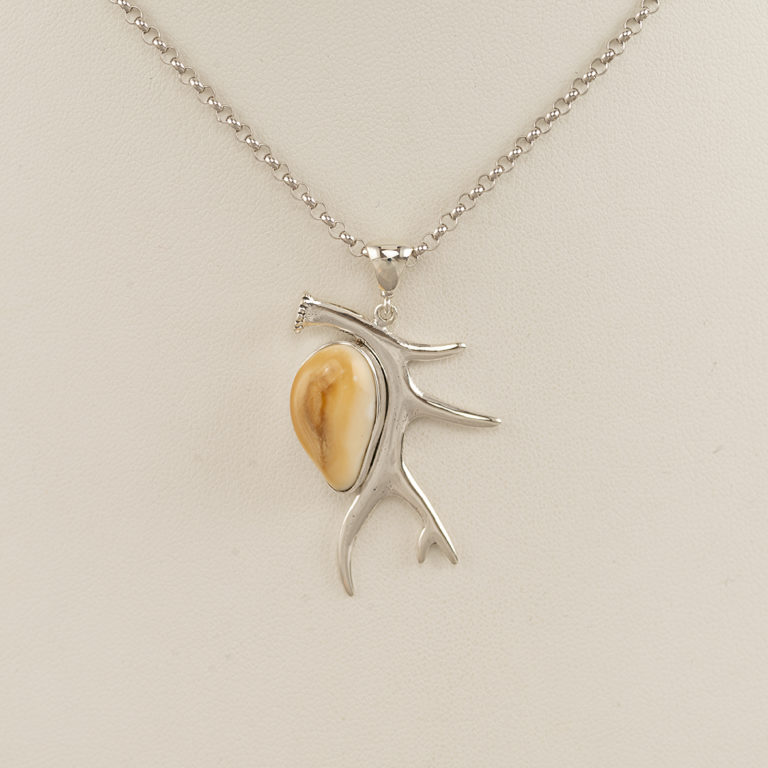 This silver antler pendant has an elk ivory accent. The elk ivory is from a bull and the chain is included in the price.