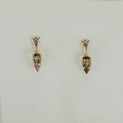 These tourmaline earrings have been cast in 14kt yellow gold. They have fancy color sapphire accents. We also have a pendant to match. 