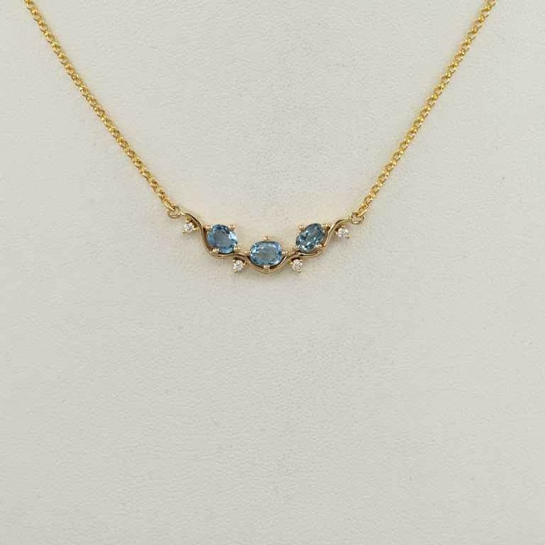 Here is an Aquamarine Pendant. Diamonds have been used to accent the Aquamarine stones. Both the diamonds and the aquamarine have been set in 14kt yellow gold. The chain is included in the price.