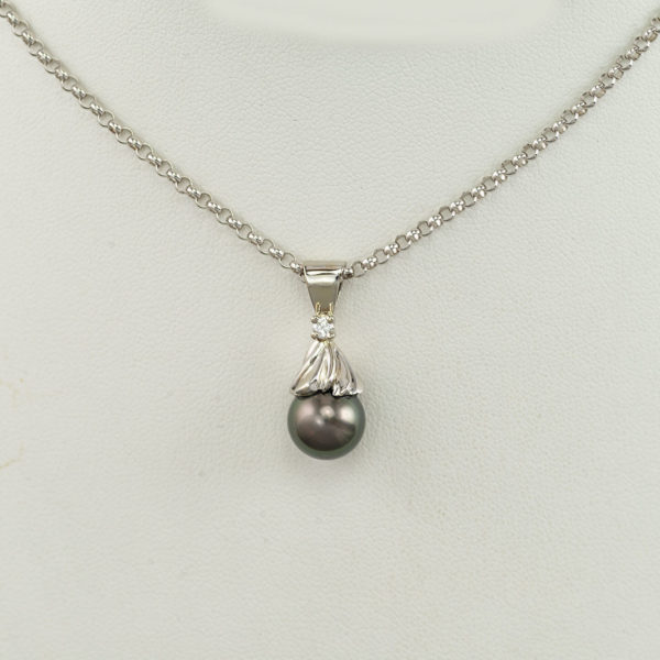 This pearl pendant is one-of-a-kind. Accenting the South Sea pearl is a diamond. Both the pearl and the diamond have been set in 14kt white gold. The chain is not included in the price.