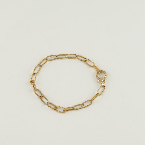 Paperclip bracelet in 14kt yellow gold. Each paperclip has white diamonds set on all sides. Shown in a size 7.25".