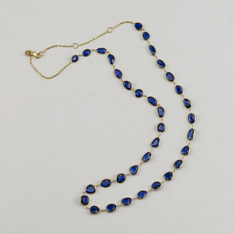 This Sapphire and Gold necklace is adjustable. It can be worn at 16", 17" or 18". The clasp is a lobster claw. The sapphires measure 12.4cts.