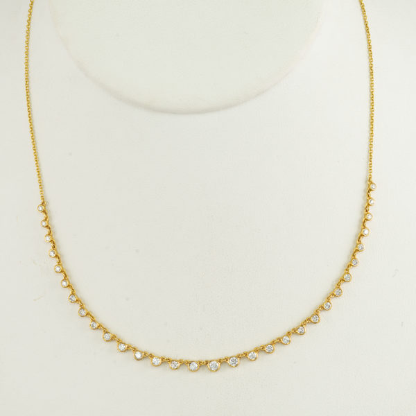 This diamond and gold necklace is adjustable. The gold is 14kt and the diamonds are round, brilliant cut. Can be worn 16", 17" or 18".
