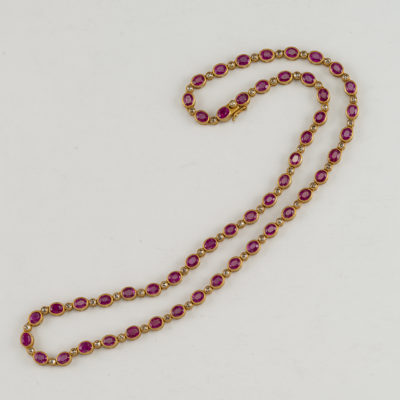 This ruby necklace has diamond accents. Both the diamonds and the rubies have been set in 14kt yellow gold. The length is 18".
