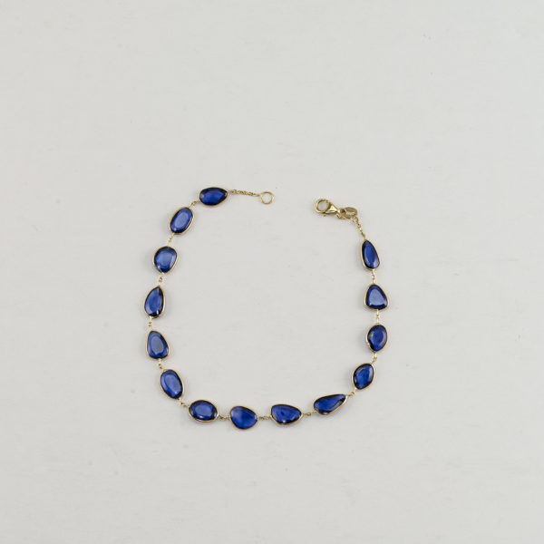 Here is a Sapphire bracelet in 14kt yellow gold. Featuring a lobster claw clasp and shown in a size 7.5".