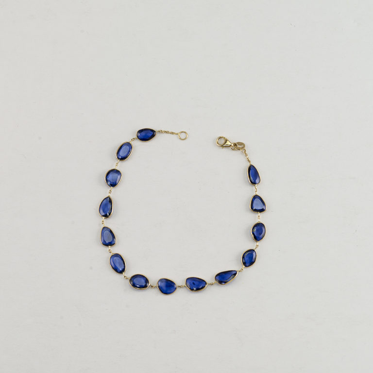 Here is a Sapphire bracelet in 14kt yellow gold. Featuring a lobster claw clasp and shown in a size 7.5".