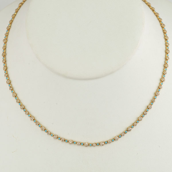This Sleeping Beauty turquoise necklace was cast in 14kt yellow gold. Accenting the turquoise are brilliant cut diamonds. This necklace is 18"