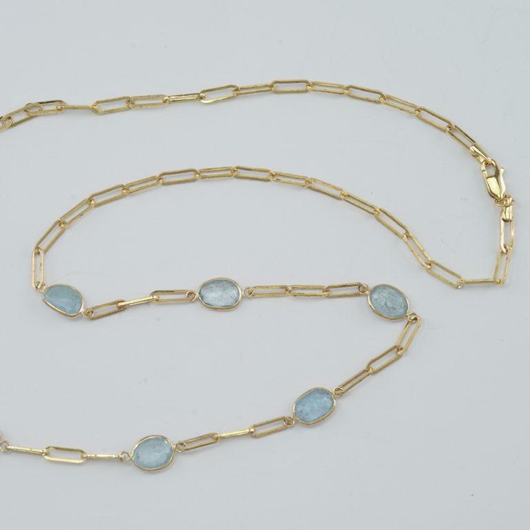 These aquamarine paperclip necklace was made with 14kt yellow gold. There are 7cts of aquamarine and it is 20" in length. 