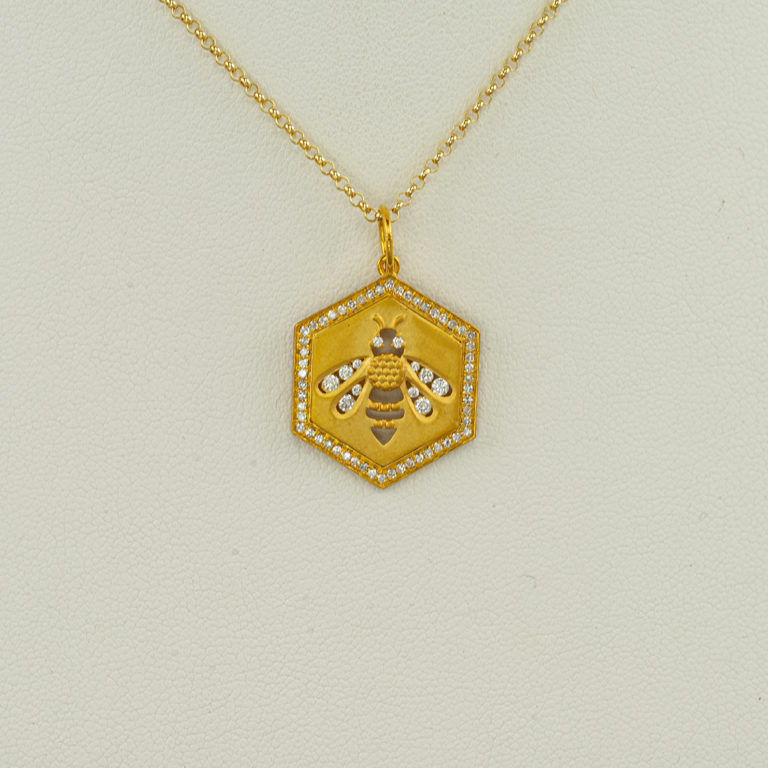 This bumblebee pendant has been cast in 14kt yellow gold. There are .60cts of white diamonds set in the pendant. The chain is not included.