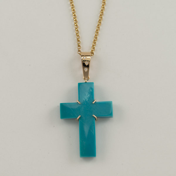 Chrysocolla cross in 14kt yellow gold with diamond accents. The diamonds are round, brilliant cut and have been flush set.