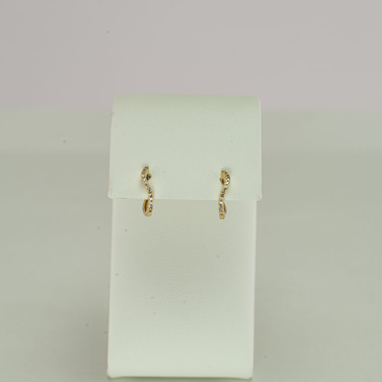 This pair of gold huggie hoops has a diamond accent. The gold is 14kt and the diamonds have been brilliant-cut. Also available in 14kt white gold.