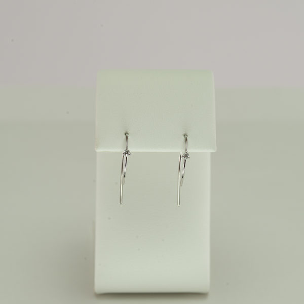 Here we have a wire hoop earring in 14kt white gold. Each hoop earring has a single brilliant-cut diamond. Also, available in 14kt yellow gold.