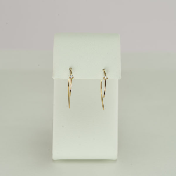 This gold wire hoop has a diamond accent. The small hoop earring was made using 14kt yellow gold. Also available in 14kt white gold.
