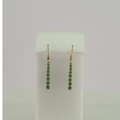 These emerald earrings have been set in 14kt yellow gold. They have been made with leverbacks and feature seven emeralds.