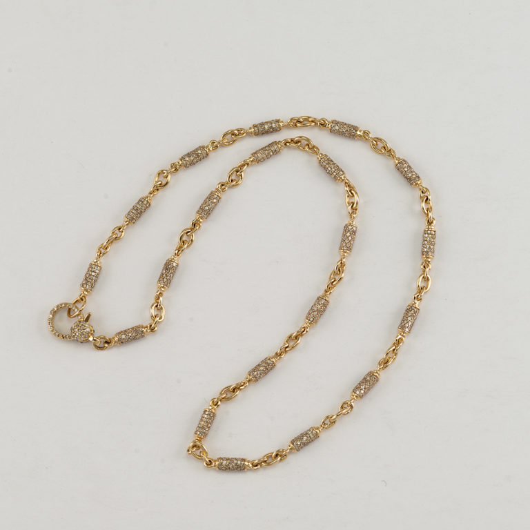 Here is a silver and gold necklace. The sterling silver and 14kt yellow gold have been paved with 6.81cts of diamonds. The length is 18".