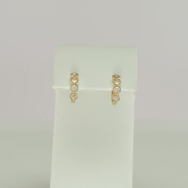 Here we have a pair of moonstone earrings. These hoops have been made with 14kt yellow gold. We offer a necklace to match.