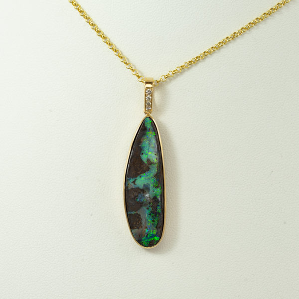 This boulder opal pendant with diamond accents. Both the diamonds and the boulder opal have been set in 14kt yellow gold. The chain is not included in the price.