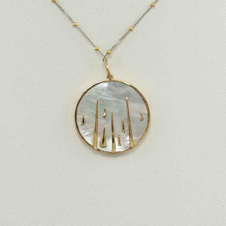This mother of pearl pendant is reversible. Accenting the mother of pearl are diamond accents. The chain is not included in the price.