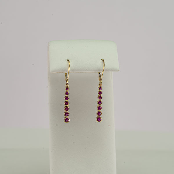 Here is a pair of ruby dangle earrings. They have been made with 14kt yellow gold. We also offer this style in sleeping beauty turquoise.